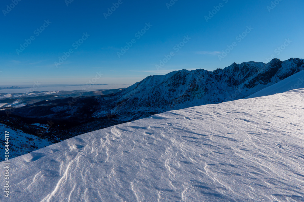 Beautiful winter scenery of Swinica and Beskid Peak from Kasprowy Wierch Peak in Tatras Mountains, famous place in Tatras with cable railway. Poland. Tatra National Park