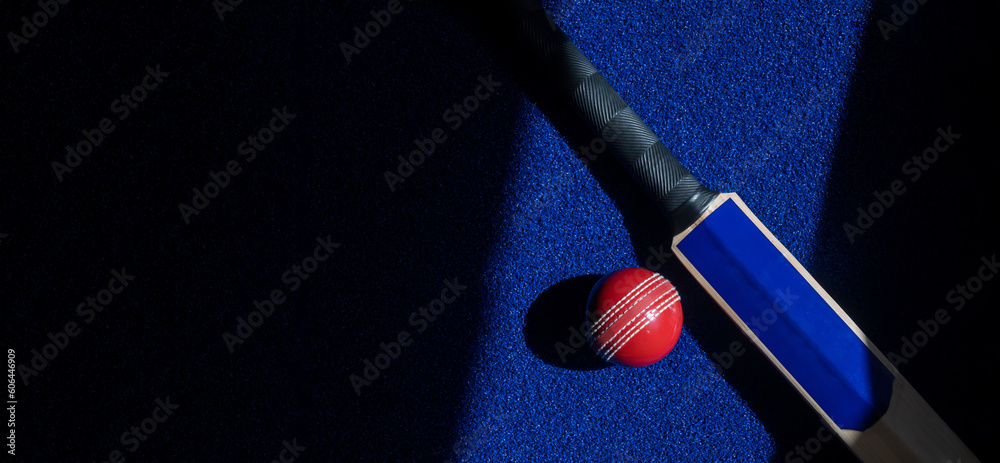 Cricket bat and red ball with natural lighting on blue background. Horizontal sport theme poster, greeting cards, headers, website and app Cricket bat and red ball with natural lighting on blue background. Horizontal sport theme poster, greeting cards, headers, website and app