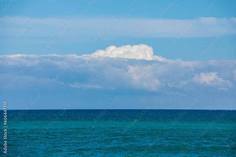 blue sky and sea with large clouds
