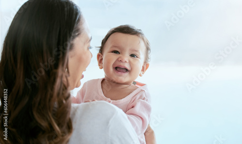 Baby laughing, portrait and mom in a home with newborn, care and parent love together with mockup. Face, family and young girl child with mother back in a house with mama and childcare in lounge photo