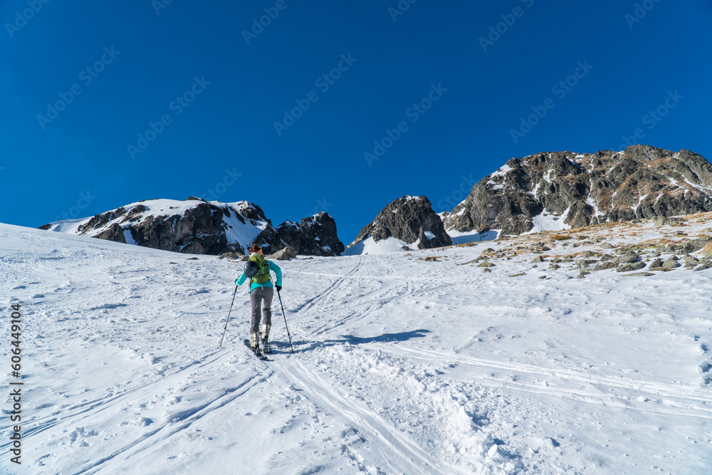 Ski touring in high alpine landscape with snowy trees. Adventure, winter activities, skitouring in spectacular mountains, Tatras mountain in Slovakia and poland Europe