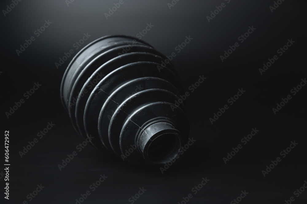 New car parts. Car wheel joint boot, CV joint rubber boot, on a black background New car parts. Car wheel joint boot, CV joint rubber boot, on a black background