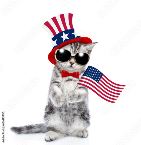 Cute kitten wearing like Uncle Sam holds USA flag. isolated on white background