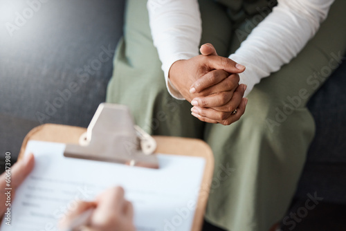 Woman, hands and therapist writing on clipboard in consultation for mental health, psychology or healthcare. Hand of female person or psychologist consulting patient with anxiety or stress in therapy photo
