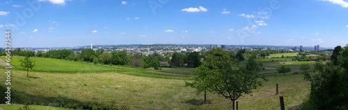 Wide angle landscape at City of Zürich district Schwamendingen with orchard, meadow and skyline in the background on a sunny spring day. Photo taken May 26th, 2023, Zurich, Switzerland. © Michael Derrer Fuchs