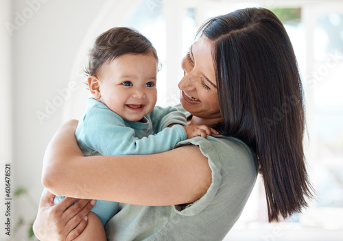 Obraz na plátně Mother holding happy baby in home for love, care and quality time together to nurture childhood development