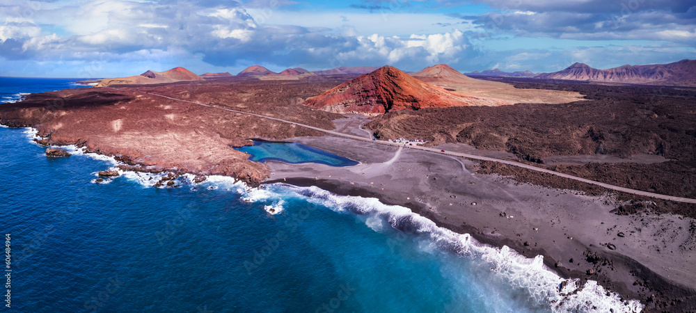 Volcanic Lanzarote island scenery. aerial  panoramic drone view  of Los Hervideros caves and cliffs and Red mountain . popular tourist destination Canary islands.