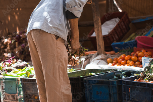 Cropped man choosing fruits in market photo