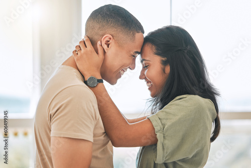 Couple, love and forehead touch in home for happiness, intimacy and relax for romance, bonding and trust together. Happy man, woman and hug partner for quality time, care and smile for commitment