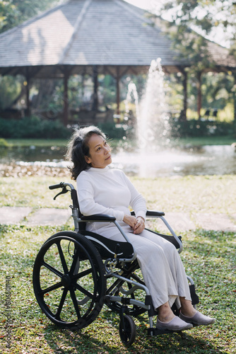 young asian physical therapist working with senior woman on walking with a walker