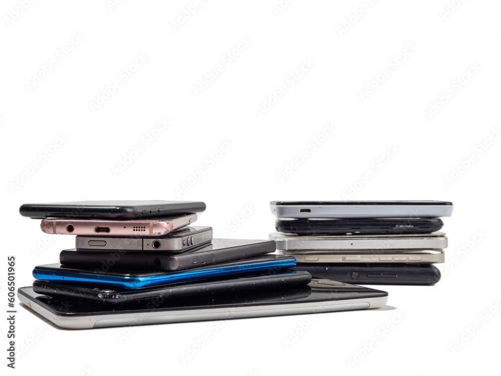 Damaged mobile phones. A bunch of broken smartphones. Used phones on a light background. Damaged mobile phones. A bunch of broken smartphones. Used phones on a light background.