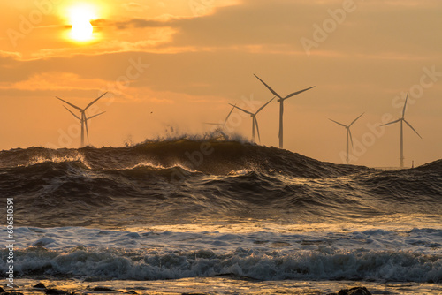 Wind turbines battered by waves photo