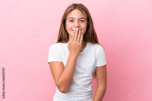 Little caucasian girl isolated on pink background happy and smiling covering mouth with hand
