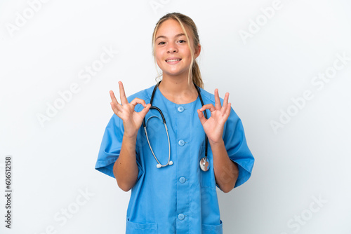 Little caucasian girl disguised as surgeon isolated on white background showing an ok sign with fingers