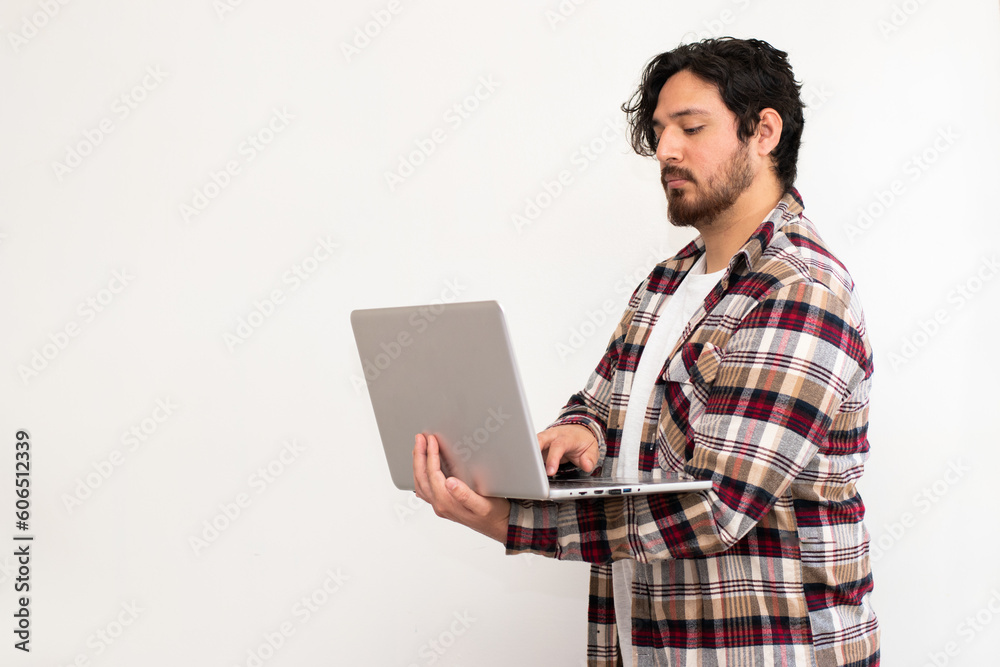 Portrait of serious person using the laptop stand up in white background and copy space Portrait of serious person using the laptop stand up in white background and copy space