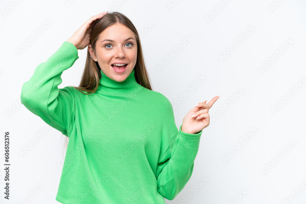 Young beautiful blonde woman isolated on white background surprised and pointing finger to the side Young beautiful blonde woman isolated on white background surprised and pointing finger to the side