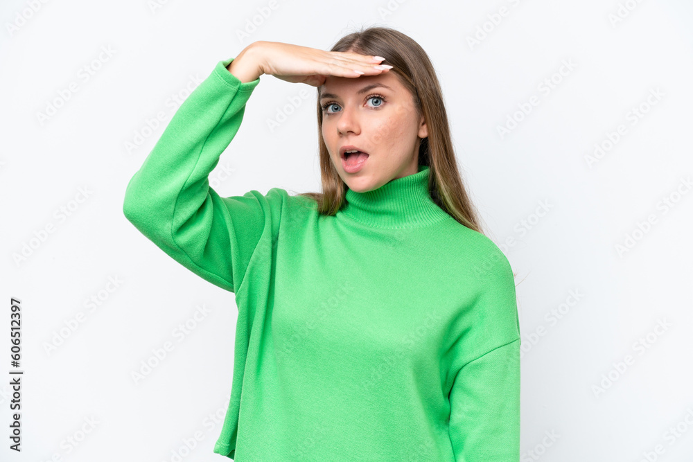 Young beautiful blonde woman isolated on white background doing surprise gesture while looking front Young beautiful blonde woman isolated on white background doing surprise gesture while looking front