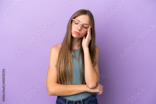 Young Lithuanian woman isolated on purple background with headache © luismolinero