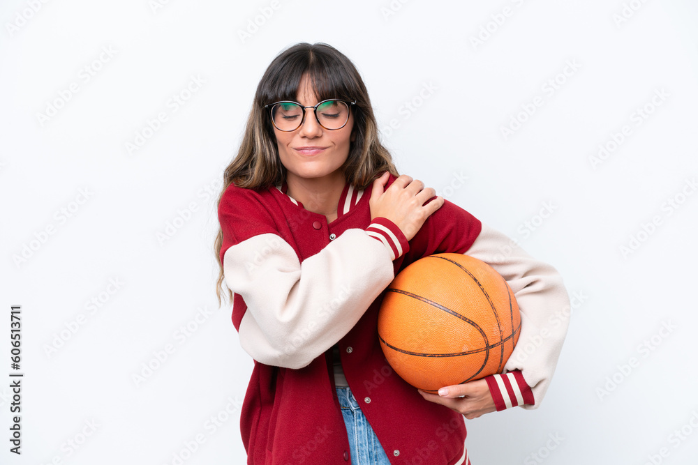 Young caucasian woman playing basketball isolated on white background suffering from pain in shoulder for having made an effort