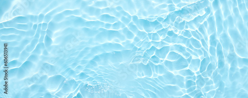 Water blue surface abstract background. Waves and ripples of cosmetic moisturizer with bubbles