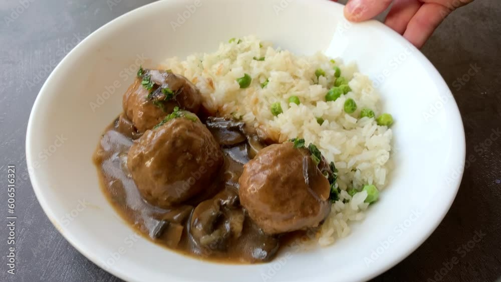 Serving Meatballs with Mushroom Sauce and Rice Serving Meatballs with Mushroom Sauce and Rice