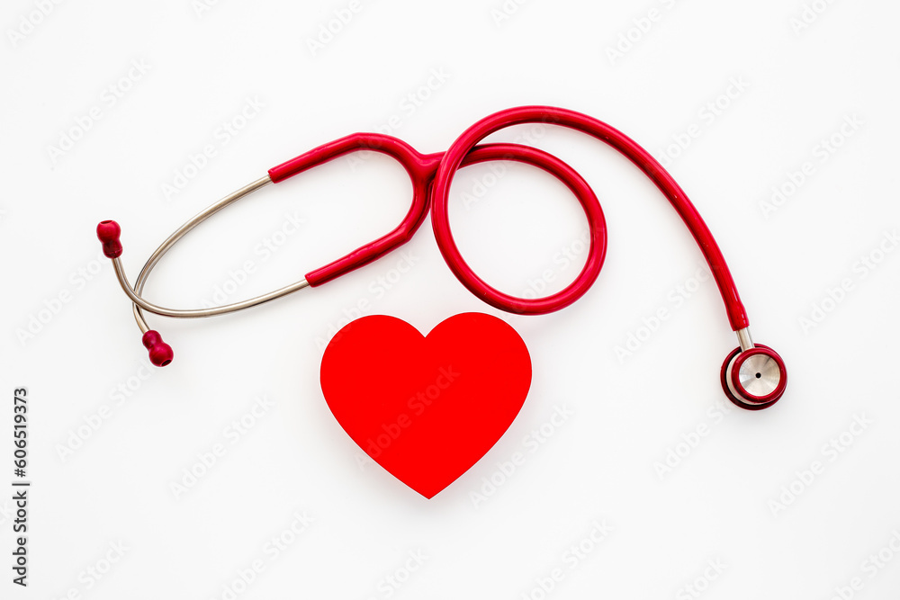 Cardiology and insurance concept with red heart and medical stethoscope Cardiology and insurance concept with red heart and medical stethoscope
