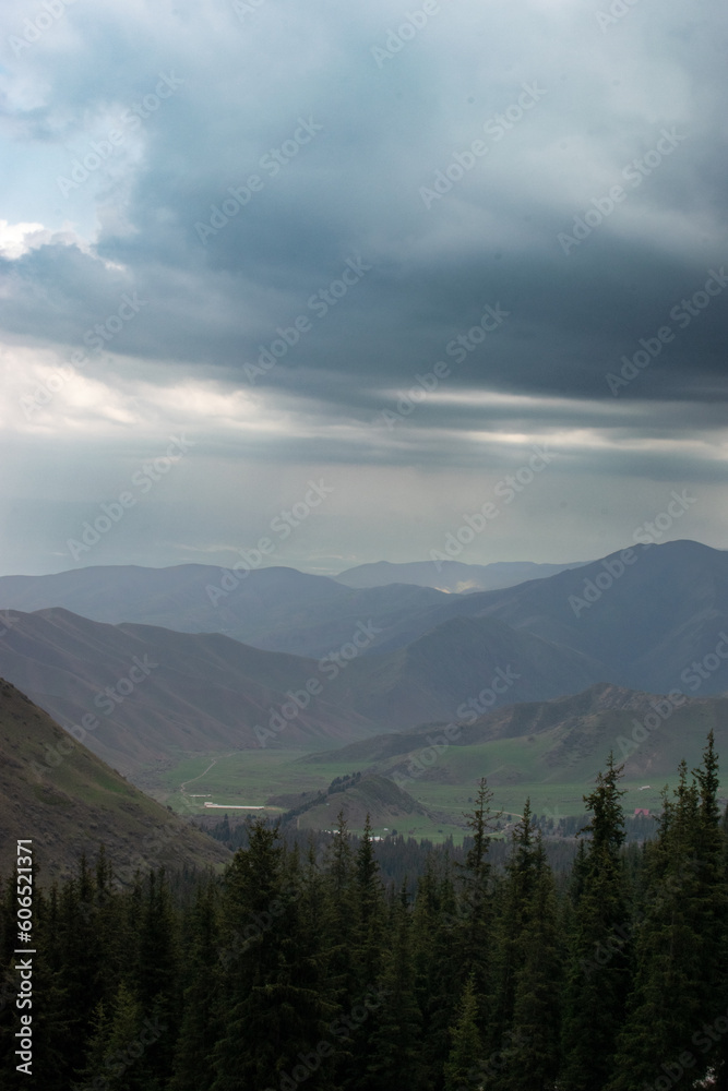 Background. High up in the mountains. Horizontal orientation. Rest on the top of the mountain in spring. Gloomy day in the mountains. Bird's-eye. Vertical orient.
