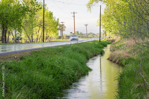 irrigation ditch and wet backcountry road in Colorado after springtime showers