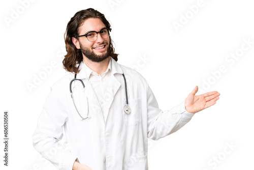 Young handsome man over isolated chroma key background wearing a doctor gown and presenting something