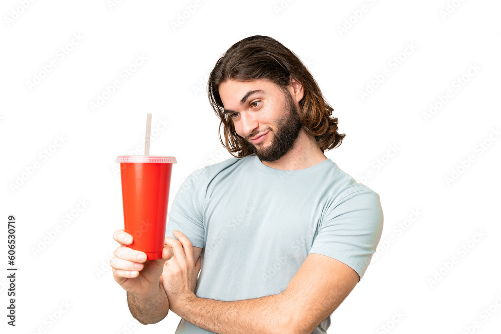 Young handsome man holding soda over isolated chroma key background with sad expression