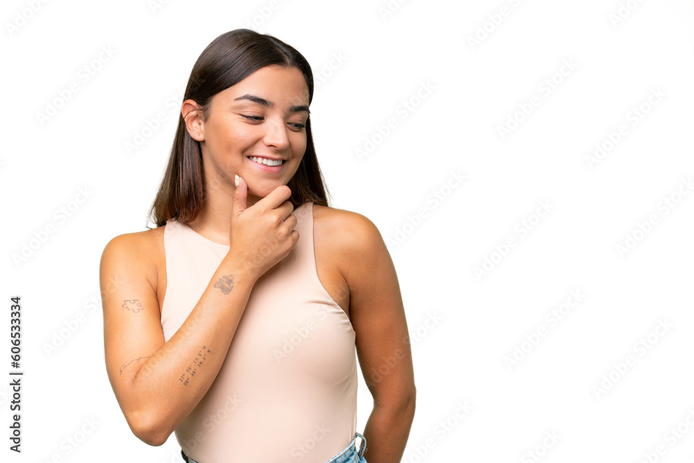 Fototapeta premium Young caucasian woman isolated on green chroma background looking to the side and smiling