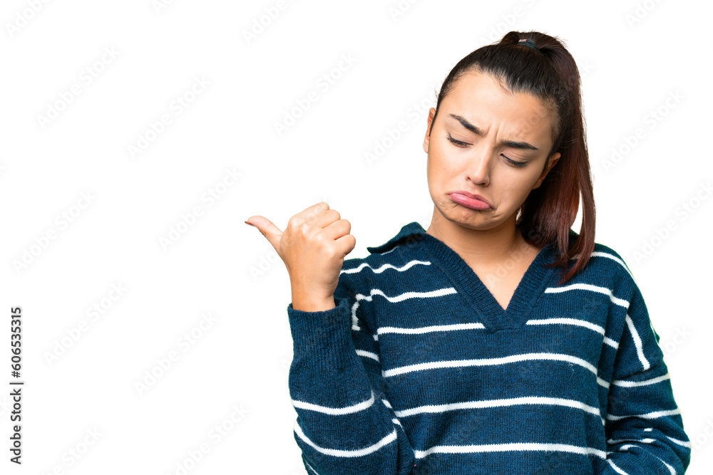 Young beauty woman over isolated chroma key background unhappy and pointing to the side Young beauty woman over isolated chroma key background unhappy and pointing to the side