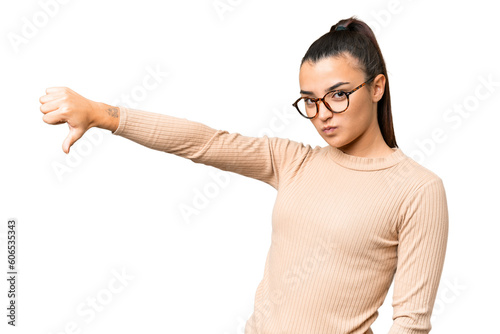 Fotografía Young beauty woman over isolated chroma key background showing thumb down with n