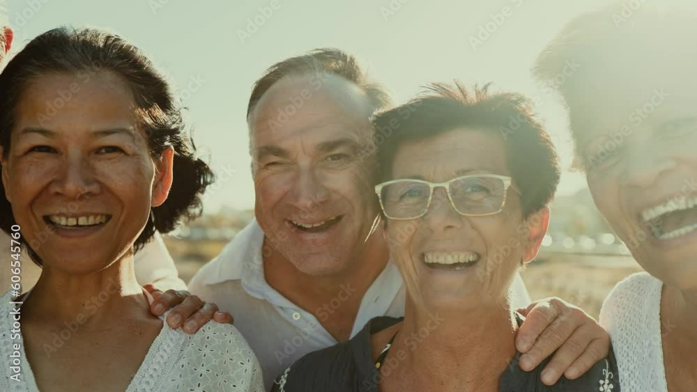 Happy multiracial senior friends having fun smiling into the camera on ...