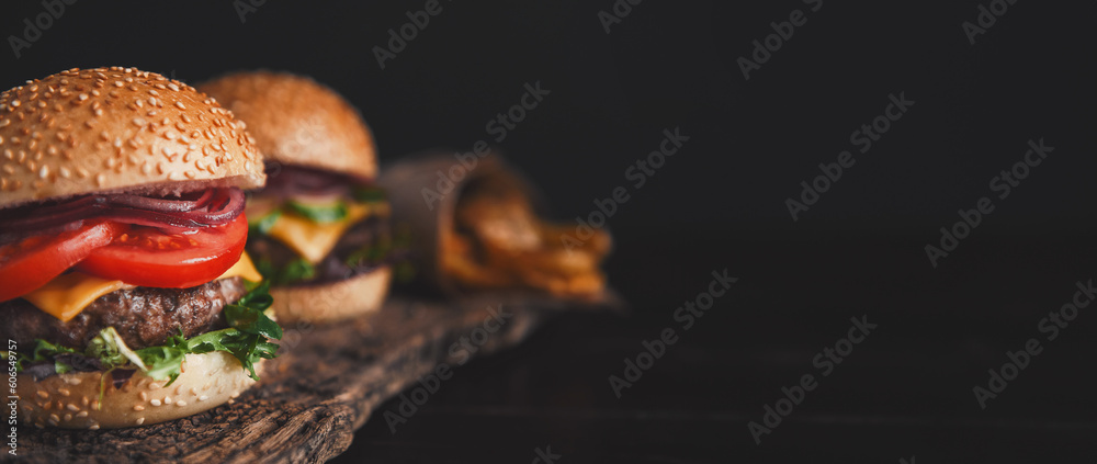 two mouth-watering, delicious homemade burger used to chop beef. on the wooden table.