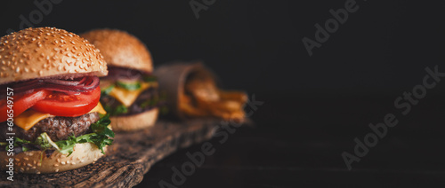Obraz na płótnie two mouth-watering, delicious homemade burger used to chop beef. on the wooden table. w salonie