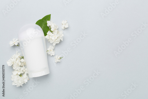 Composition with deodorant and flowers on color background  top view