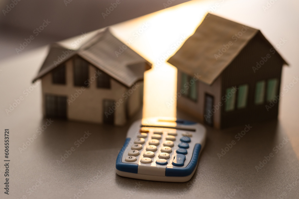 House is placed on the calculator. Imagine calculating to buy a home. planning savings money to buy a home concept for property, mortgage and real estate investment. to buy a house. House is placed on the calculator. Imagine calculating to buy a home. planning savings money to buy a home concept for property, mortgage and real estate investment. to buy a house.