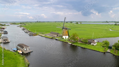 Historic windmill by the river called Zwanburgermolen near Warmond, Netherlands. photo