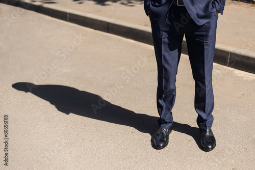 man in a business suit and black patent leather shoes. beautiful shadow