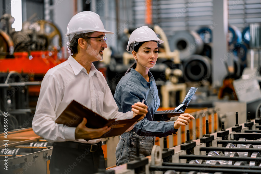 custom made wallpaper toronto digitalTwo professional engineer,worker,technician use clipboard discuss work, walk in steel metal manufacture factory plant industry. Black African American man and woman wear hard hat check quality machine