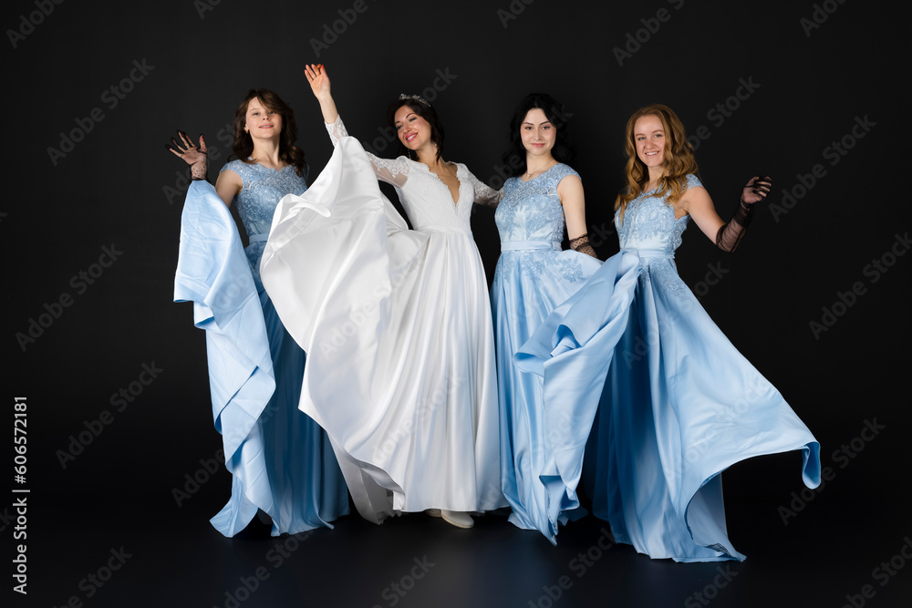 Beautiful bride in elegant white dress and Group of bridesmaids in blue dresses. three bridesmaids. isolated on black background. Beautiful bride in elegant white dress and Group of bridesmaids in blue dresses. three bridesmaids. isolated on black background.