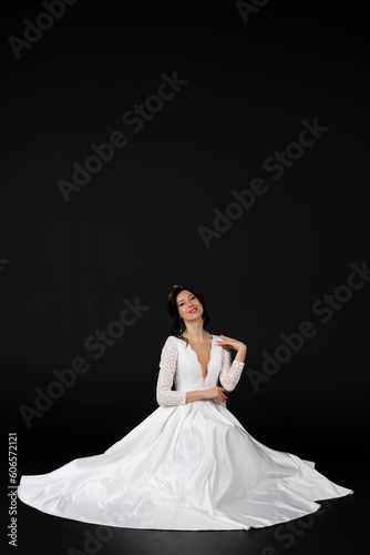 Beautiful bride in elegant exquisit white dress. isolated on black background.