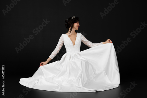 Beautiful bride in elegant exquisit white dress. isolated on black background.