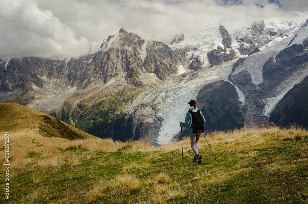 Woman hiking in the mountains with a view of the Chamonix glacier and the Mont Blanc