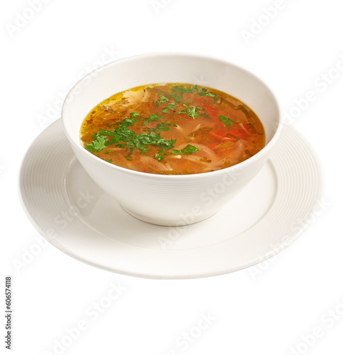 bowl of chicken broth soup with vegetables and rice isolated on white background
