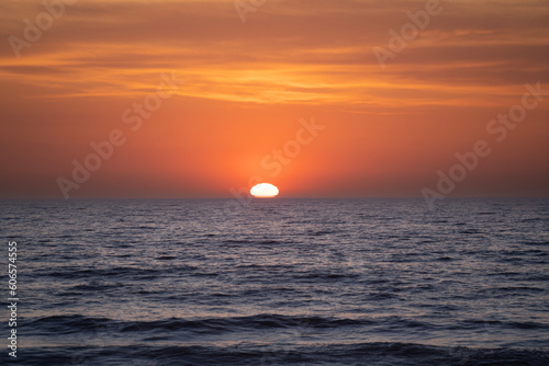 Fototapeta Naklejka Na Ścianę i Meble -  Beautiful colorful sunset at the sea with dramatic clouds and sun shining