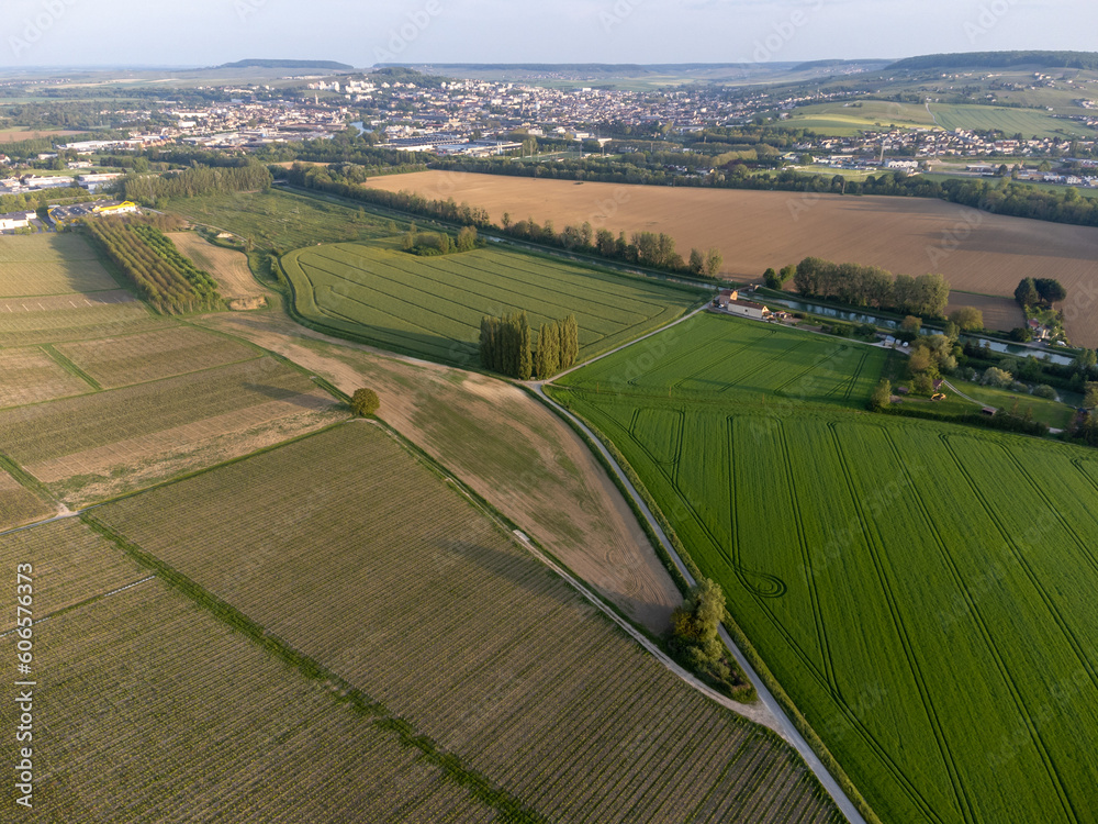 Panoramic aerial view on green premier cru champagne vineyards and fields near village Hautvillers and  Cumieres and Marne river valley, Champange, France
