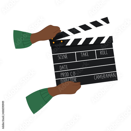 A pair of black hands holding a movie slate.