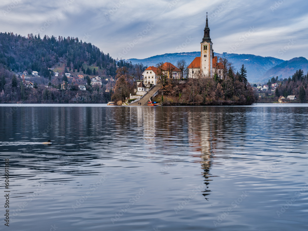 Lake Bled island church and bled town in the background during a cloudy afternoon, Bled, Slovenia